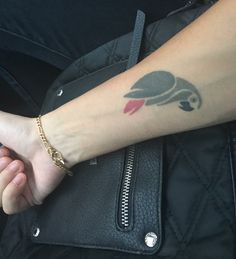 a woman's arm with a tattoo on it and a bird on the wrist