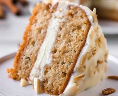 a slice of cake with white frosting on a plate