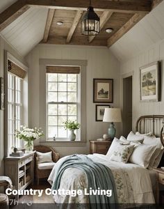 a bed sitting under a window next to a wooden table and chair in a bedroom