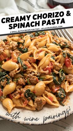 a plate full of pasta with spinach and sausage