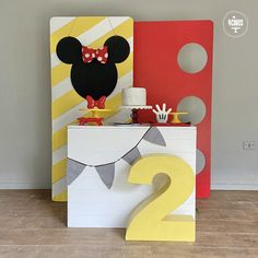 a mickey mouse birthday party with decorations and decor on the sideboard, including a sign that says 2