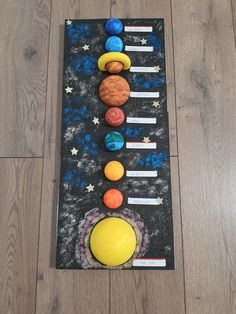 the solar system is made out of clay and paper machs on a wooden floor