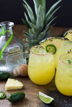 pineapple margaritas with lime and jalapenos on the side