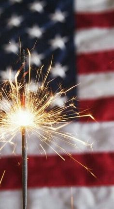 a sparkler in front of an american flag