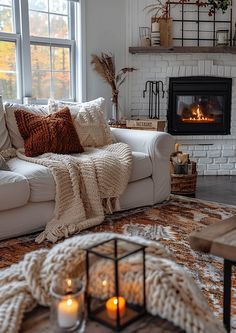 a living room filled with furniture and a fire place in front of a large window