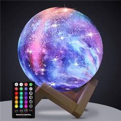 an image of a colorful ball with stars on it next to a wooden stand and remote control