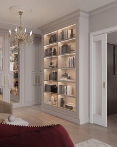 a living room filled with furniture and a chandelier