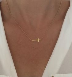 Gold Cross Necklace  D E T A I L S: *Gold cross approx 9mm x 23mm *Stainless Steel with Anti Tarnish 14k Gold Plating *Model wearing 18" length  SHIPPING: *Free domestic shipping on all orders  PACKAGING: *All pieces come  packaged in a jewelry box, perfect for gift giving.  Visit our Shop for more Items: https://www.etsy.com/shop/TheJewelryStandard ►Social  INSTAGRAM: https://www.instagram.com/thejewelrystandard/ FACEBOOK: https://m.facebook.com/thejewelrystandard/ Simple Cross Jewelry For Gifts, Minimalist Cross Necklaces For Mother's Day, Minimalist Cross Necklace For Mother's Day, Delicate Cross Pendant Necklace For Gift, Minimalist Gold Cross Necklace As Gift, Delicate Cross Necklace For Gift, Dainty Cross Necklace For Gift, Delicate Cross Necklace Perfect As A Gift, Simple Gold Cross Necklace As A Gift