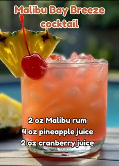 there is a drink with a cherry on the top and a pineapple in the middle