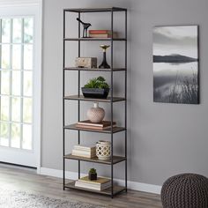 a book shelf with books and plants on it