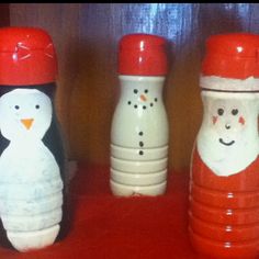 three snowman and penguin salt and pepper shakers sitting on a red tablecloth