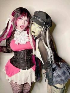 two mannequins dressed in costumes posing for the camera