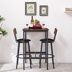 two stools and a table with wine glasses on it