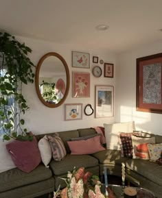 a living room filled with lots of furniture and pictures on the wall above it's coffee table