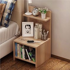 a bedroom with a bed, nightstand and bookshelf on the floor next to it