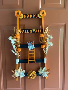 a door decorated with fall decorations and sunflowers for the front entrance to a happy fall y'all party