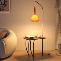 a lamp that is sitting on top of a table next to a chair and couch