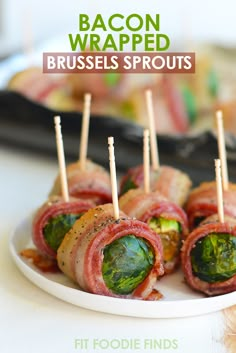 small appetizers are arranged on a plate with toothpicks