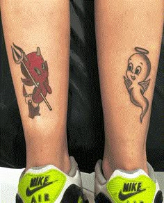 two people with tattoos on their legs, one has a dragon and the other has a devil