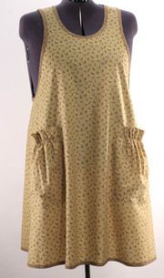 a mannequin wearing a yellow dress with black dots on the front and side