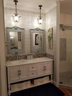 the bathroom is decorated in white and has two mirrors on the wall above the sink