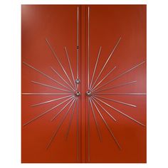 a red door with metal spikes on it