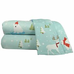 two sheets with christmas designs on them, one is blue and the other is white