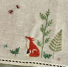 a close up of a piece of cloth with animals on it and butterflies flying in the background