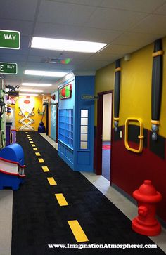 an image of a school hallway that is painted in bright colors and has signs on the wall