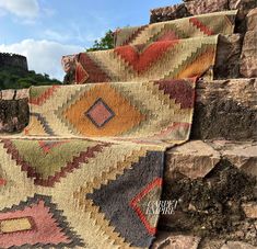 two colorful rugs sitting on top of stone steps