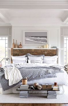 a large bed sitting in a bedroom next to a wooden headboard and foot board