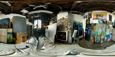 the fisheye lens view of an art studio with multiple paintings on it's walls