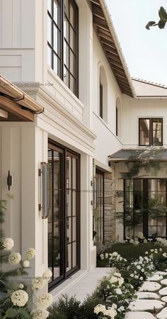 a house with white flowers in the front yard