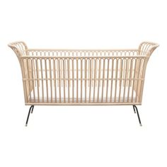 a white baby crib with black legs