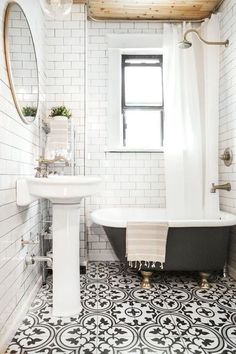 a bath room with a sink and a bath tub next to a window on the wall