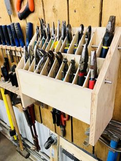 a wooden tool rack filled with lots of tools