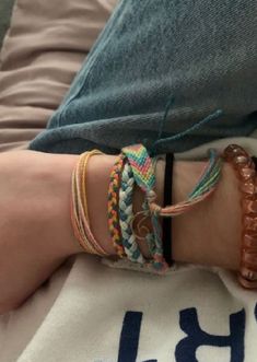 Surfer Bracelets Aesthetic, Multiple Bracelets Aesthetic, Bracelet Asethic, Cute Bracelets Aesthetic, Pura Vida Bracelet Stack, Handmade Bracelets Aesthetic, String Bracelet Aesthetic, Layered Bracelets Aesthetic, Beach Bracelets Aesthetic