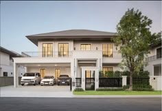 two cars are parked in front of the house