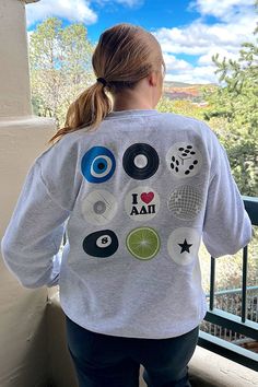 the back of a woman's sweatshirt that has various images on it