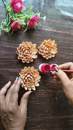 the woman is making flowers out of toilet paper and glues them with her hands