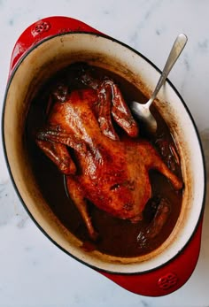 a pot filled with meat and sauce on top of a table