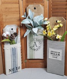 two vases filled with flowers sitting next to each other