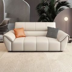 a white leather couch sitting on top of a rug