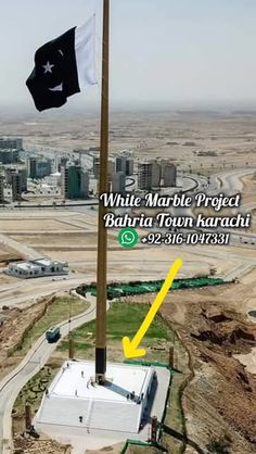 an aerial view of a flag pole with the words white marble project behind it and a black and white flag