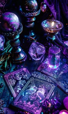 some cards and candles on a table with purple lights in the background, as well as an image of a woman's face