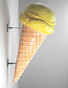 an ice cream cone with yellow icing on it