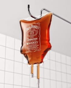 a bottle of jack daniels whiskey hanging from a hook