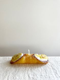 a piece of bread with an egg on it sitting on top of a white cloth