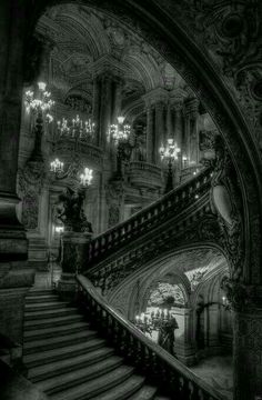 an ornate staircase and chandelier in a building