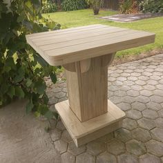 a wooden table sitting on top of a stone patio